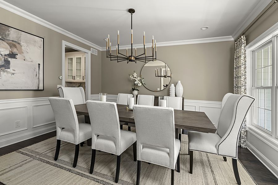 A backdrop of mocha paint contrast with the light floor and furniture. 